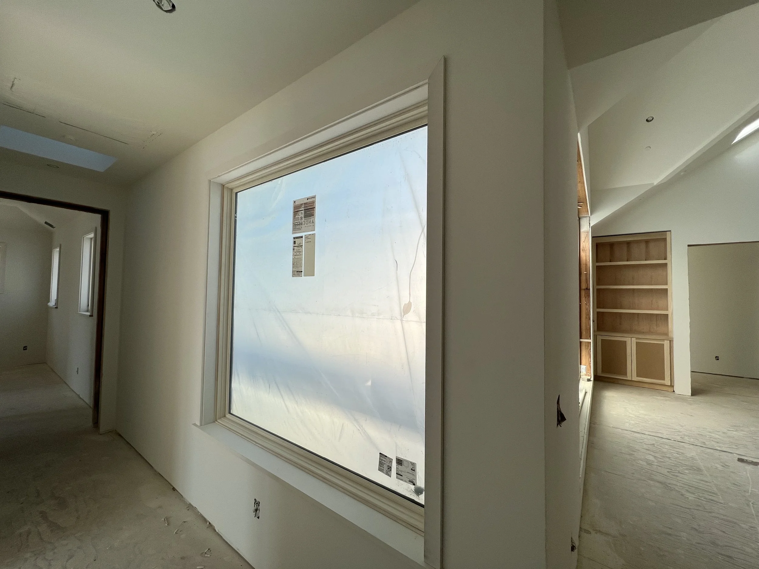 Upper level coridors will be filled with light.  The window on the left has been “trimmed out”; the one on the right waits patiently.