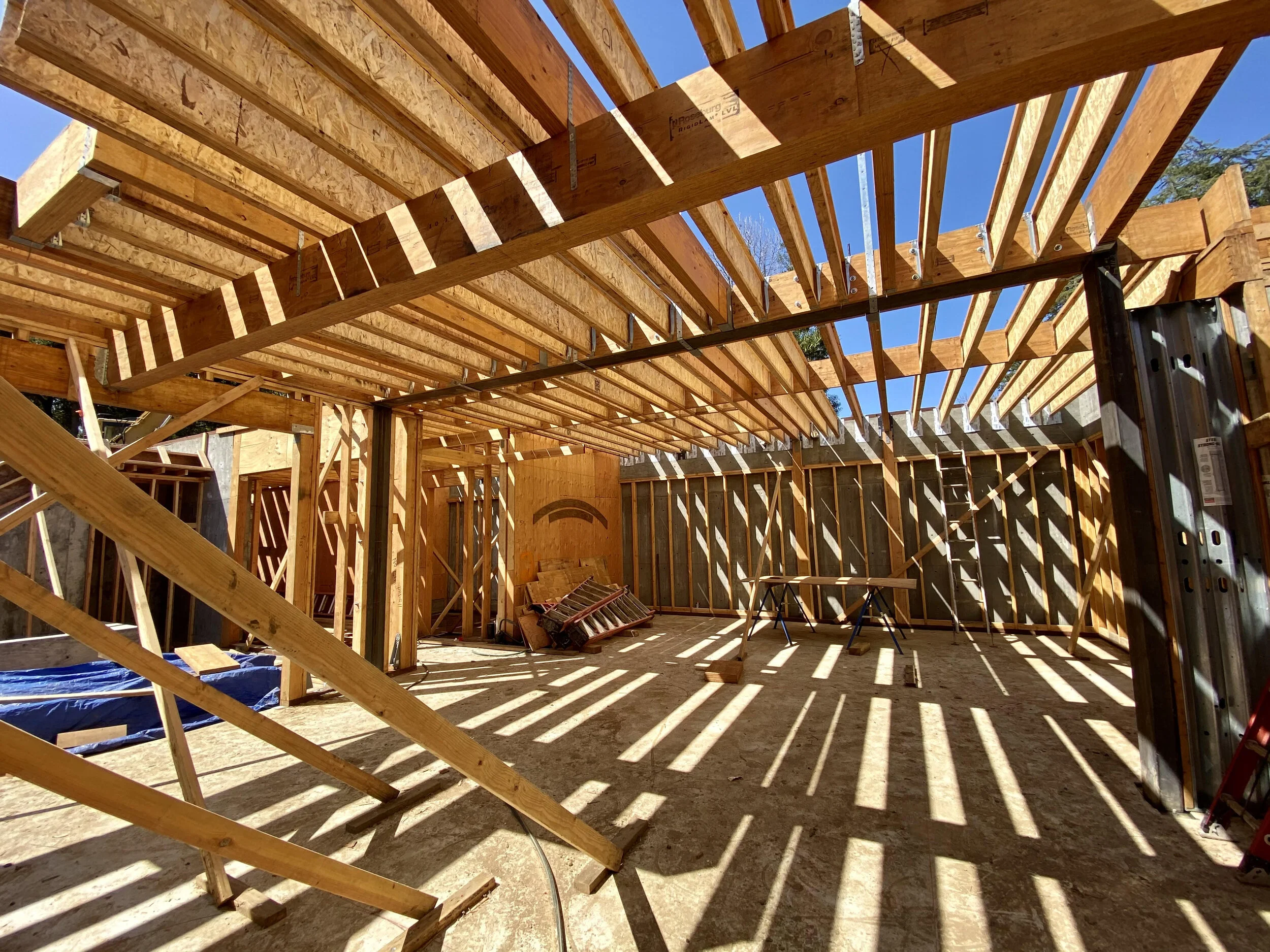 The i-beams above are the joists.  The vertical wood against the concrete are the studs.  The big thick fattie on above is a beam.  The black square arch is steel.