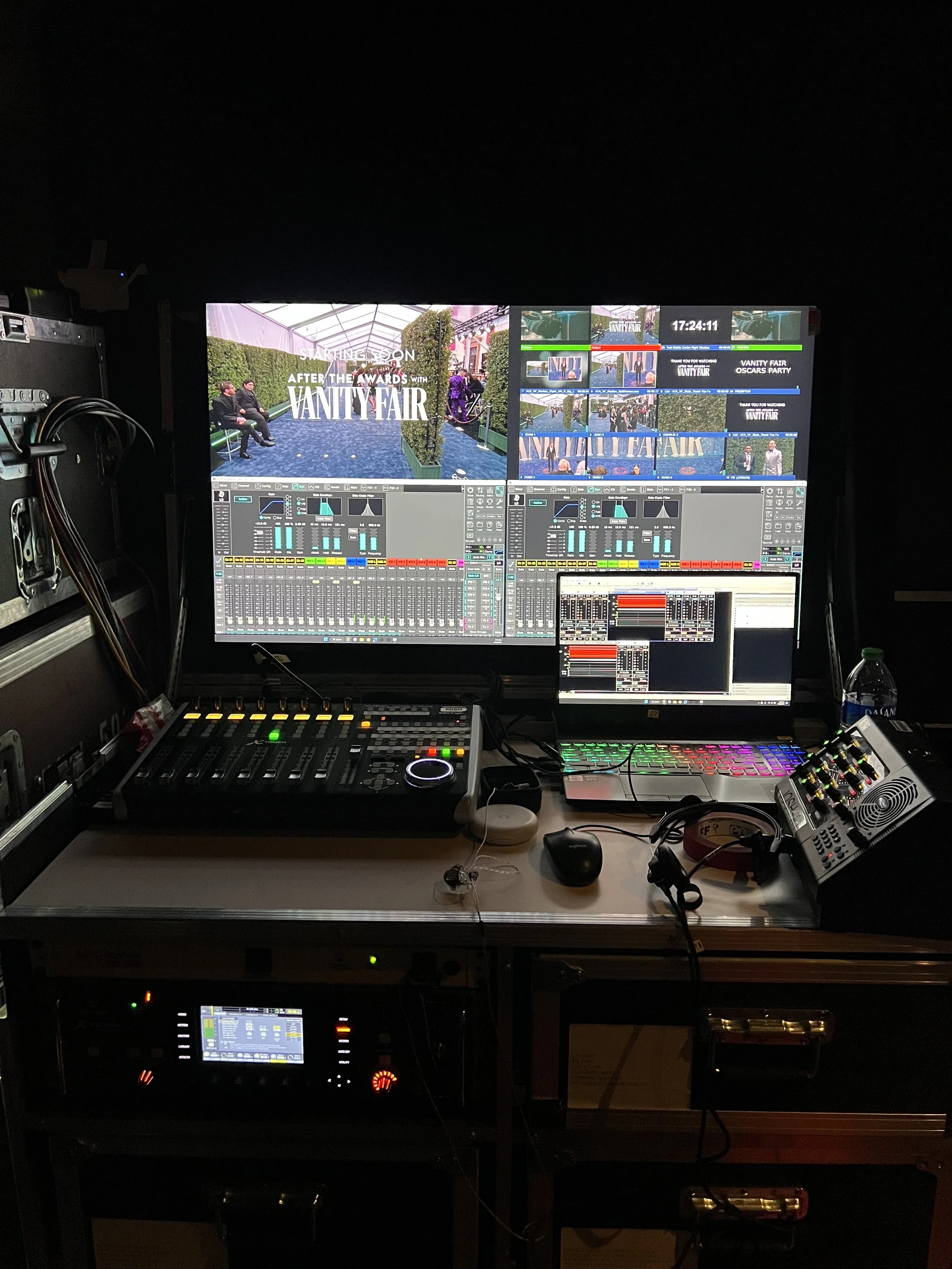Video control room with multiple screens, audio mixing console, laptop, and various electronic equipment for a Vanity Fair event.