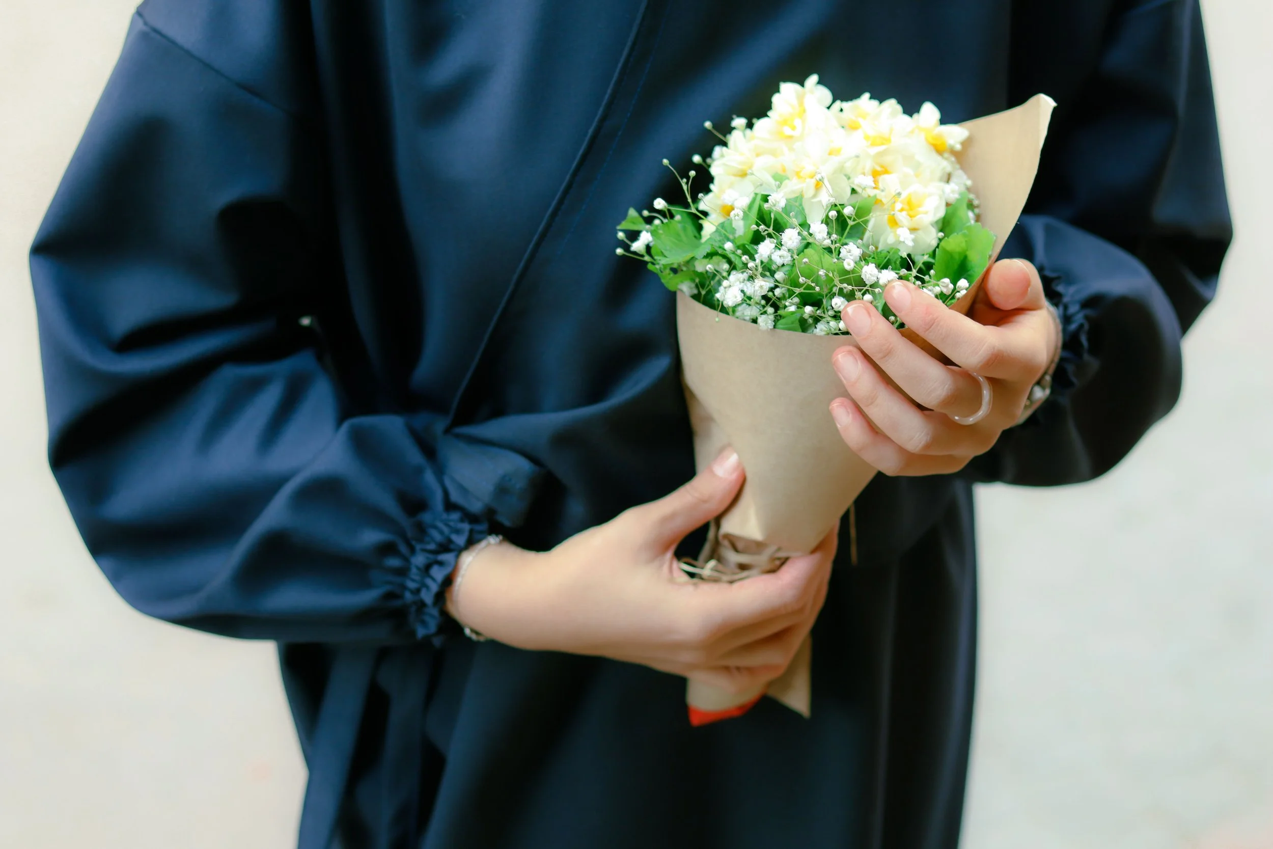 Volunteer holding rescued wedding flowers restyled into small bouquets