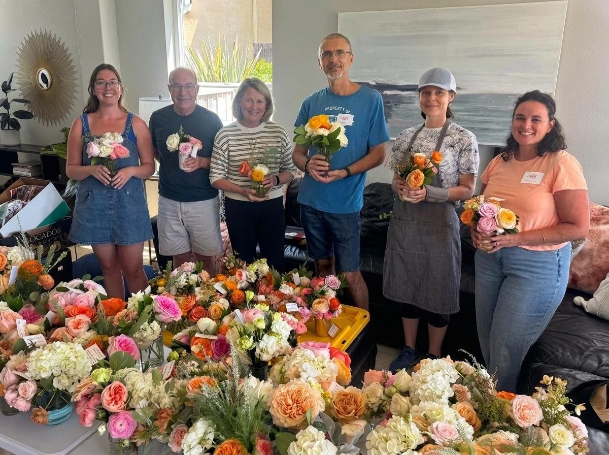 volunteers folding fresh flowers that will be delivered into San Diego.