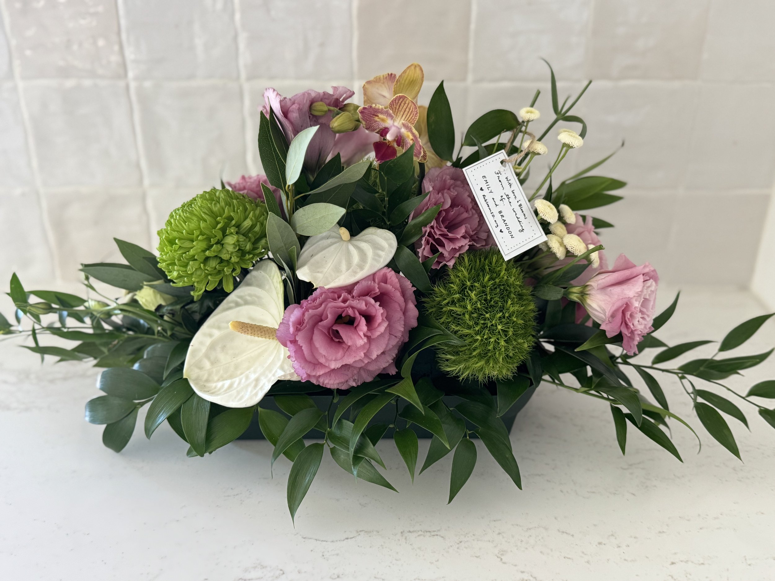 Restyled bouquet of pink roses and white anthurium with a ReBloom SD gift card that went to a memory care facility.