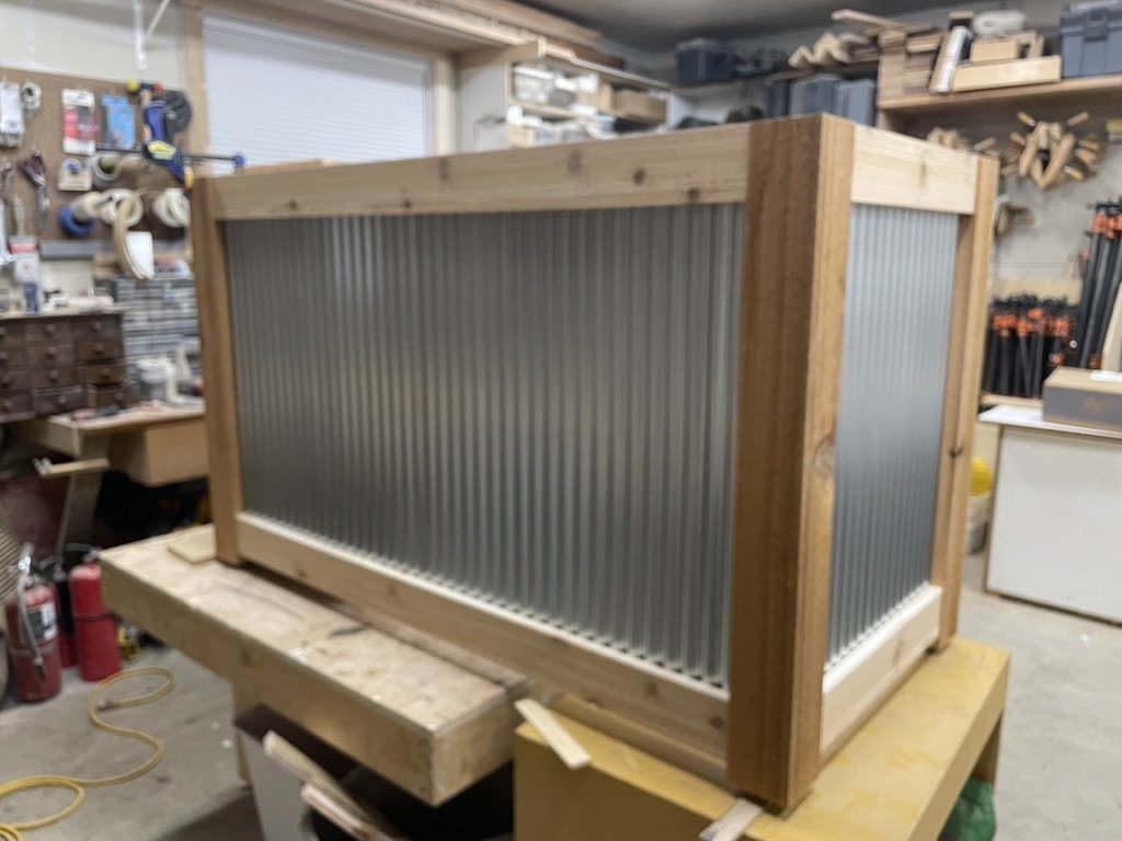 Wooden and corrugated metal frame structure in a woodworking workshop.