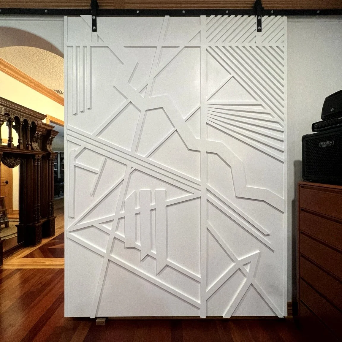 White geometric sliding doors with raised detailing