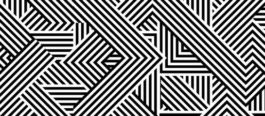 An abstract black and white geometric pattern with stripes and lines forming various angled shapes.