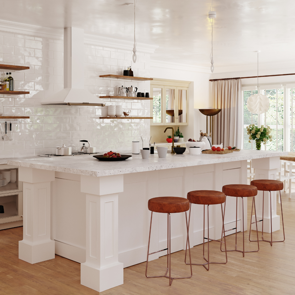 Bright, modern kitchen with white cabinetry, open wooden shelves, a large island with a white countertop, and four brown bar stools. The island has bowls, a cutting board with tomatoes, and a black plate with strawberries. The background shows a window with blinds, beige curtains, and a dining area with a vase of flowers.