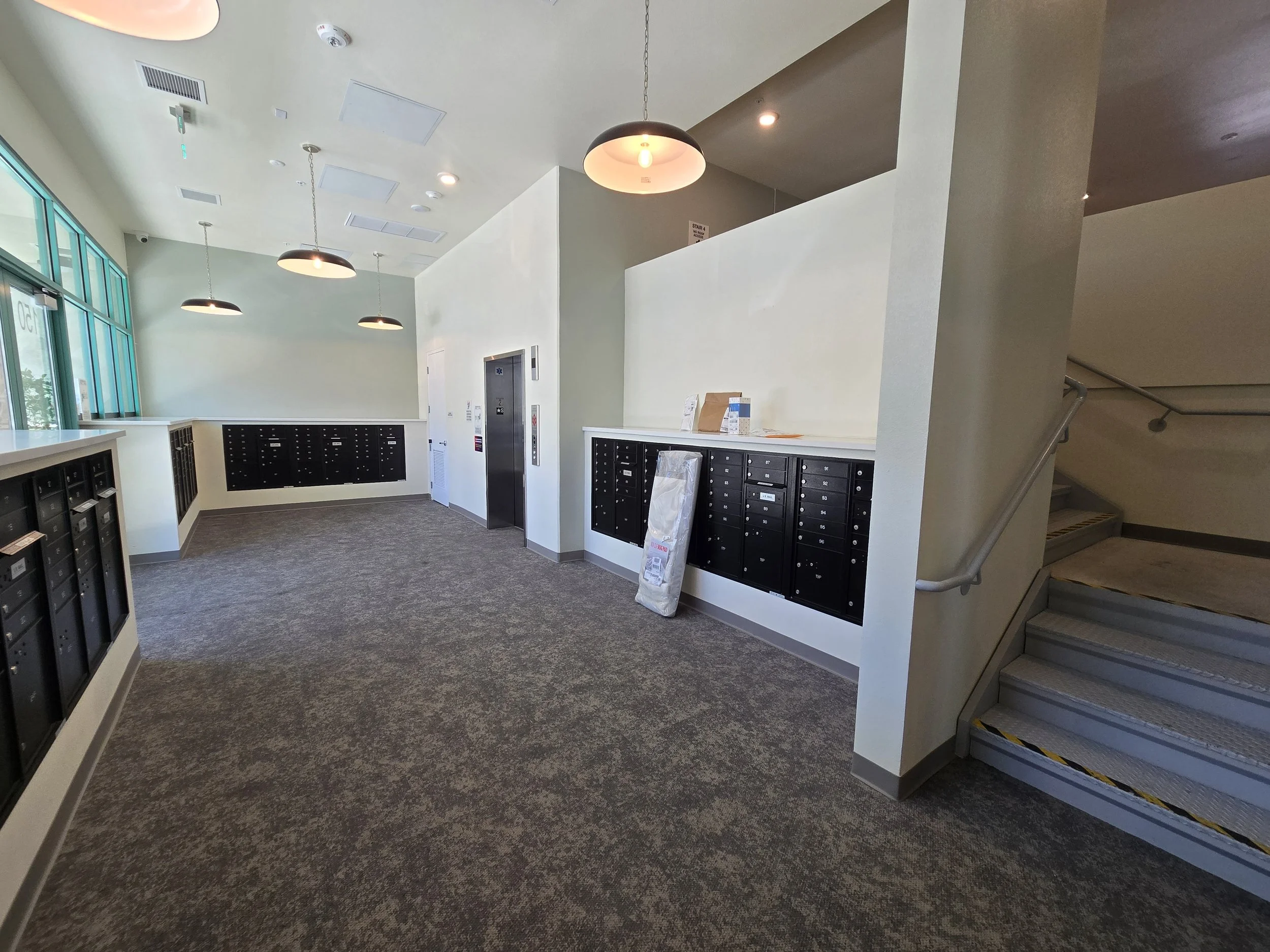 Clean apartment lobby with mailboxes and elevator maintained by B2B commercial cleaning services in the San Francisco Bay Area