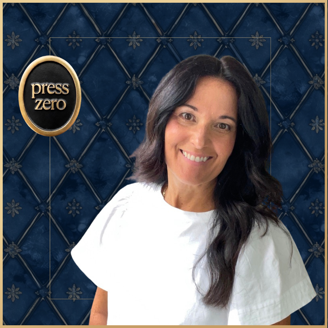 Smiling woman with dark hair in front of a blue quilted wall with a press zero logo.