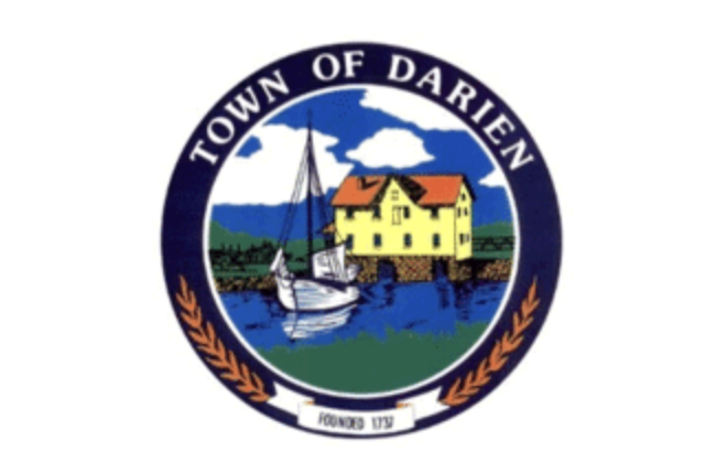 Seal of the Town of Darien featuring a yellow house with red roof, a sailboat, water, green landscape, blue sky with clouds, and a dark blue circular border with white text.