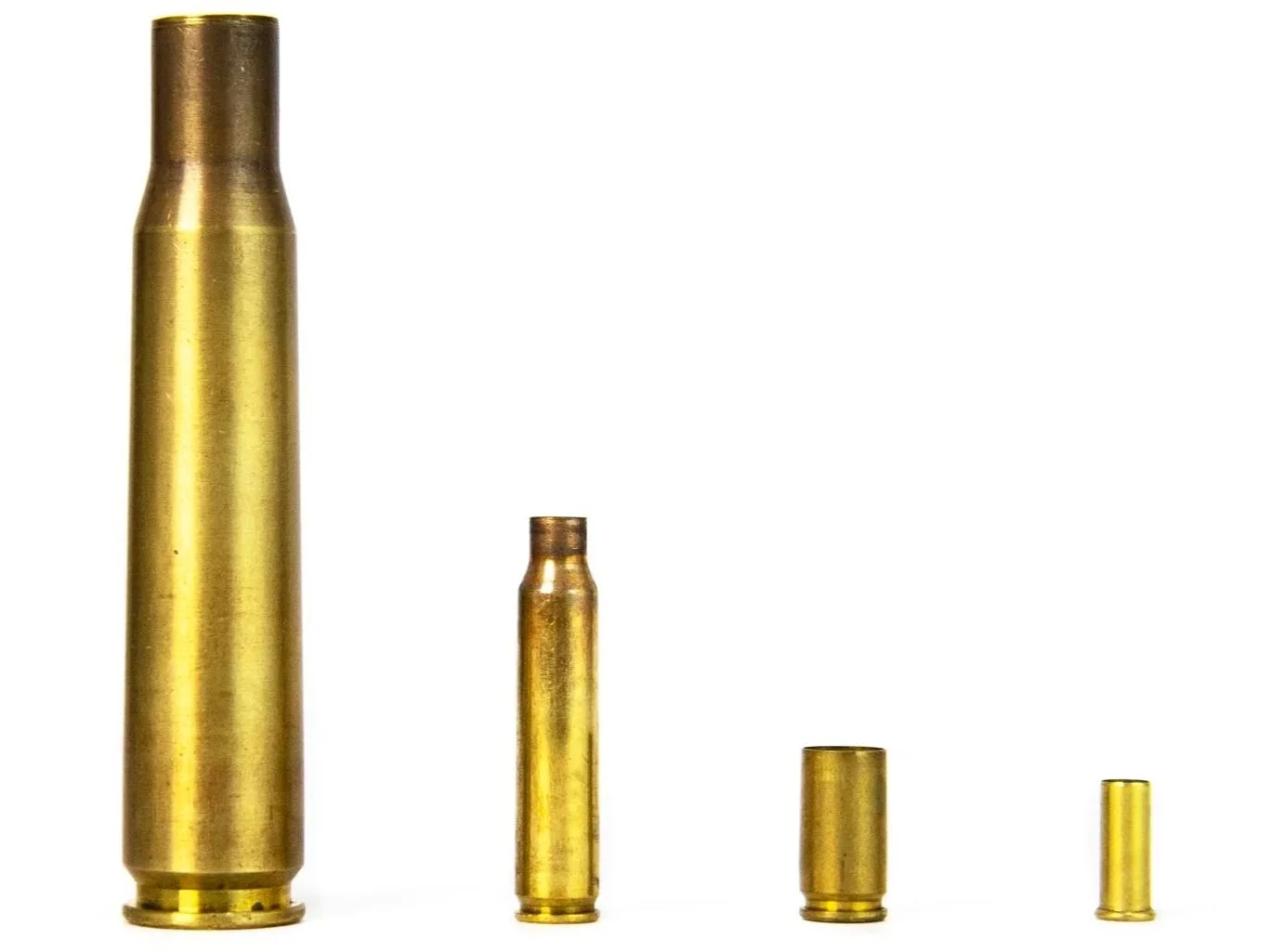 Four brass bullet casings of different sizes lined up from largest to smallest against a white background.