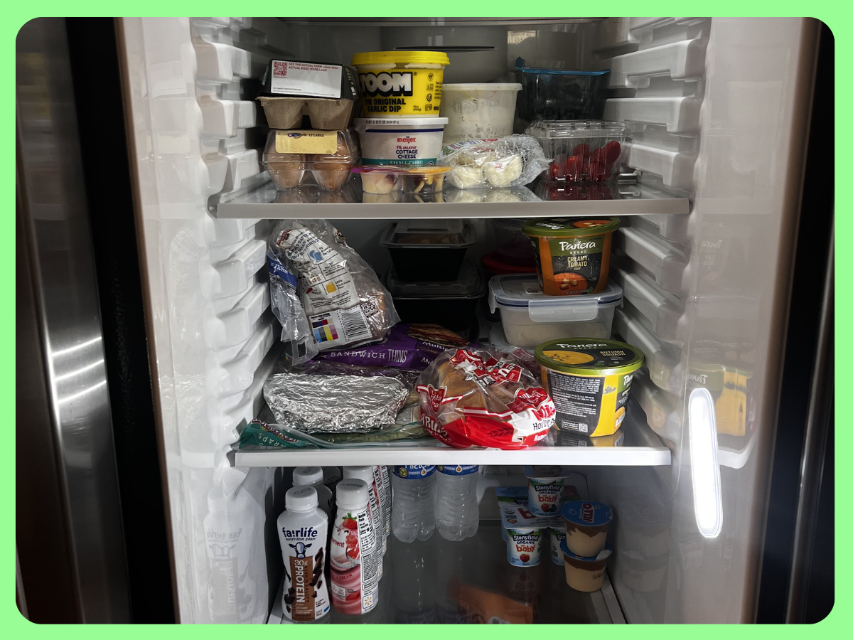 Open refrigerator with various food containers, dairy, beverages, and frozen items inside.