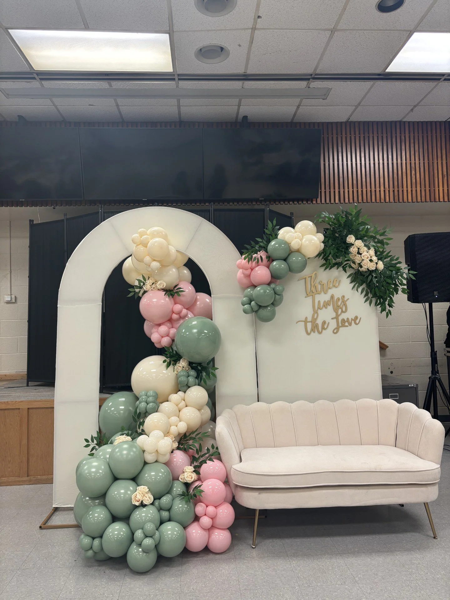 Organic Balloon Arch with custom signage, sofa and greenery details. 