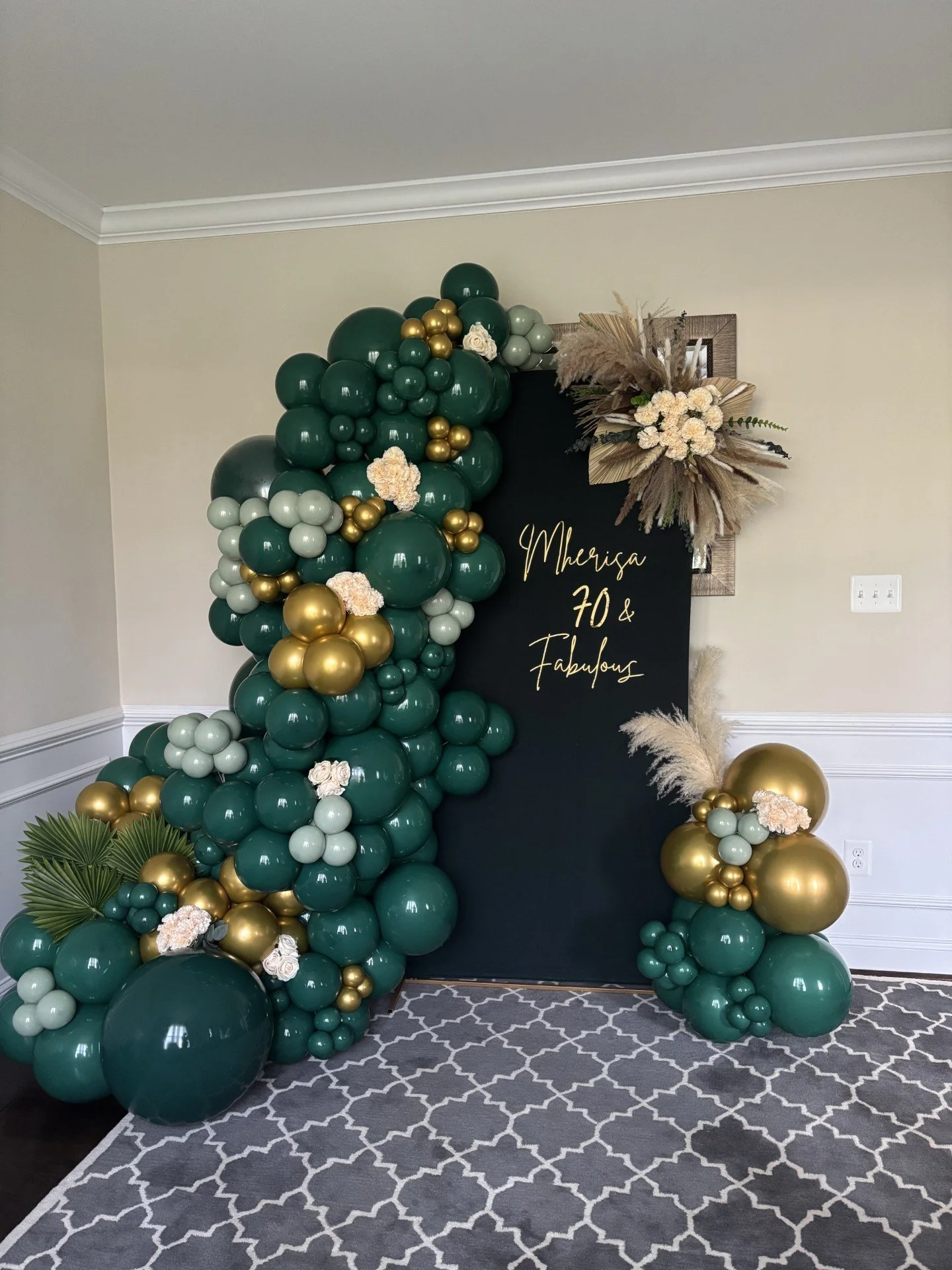 Organic Balloon Arch with custom signage and floral accents.