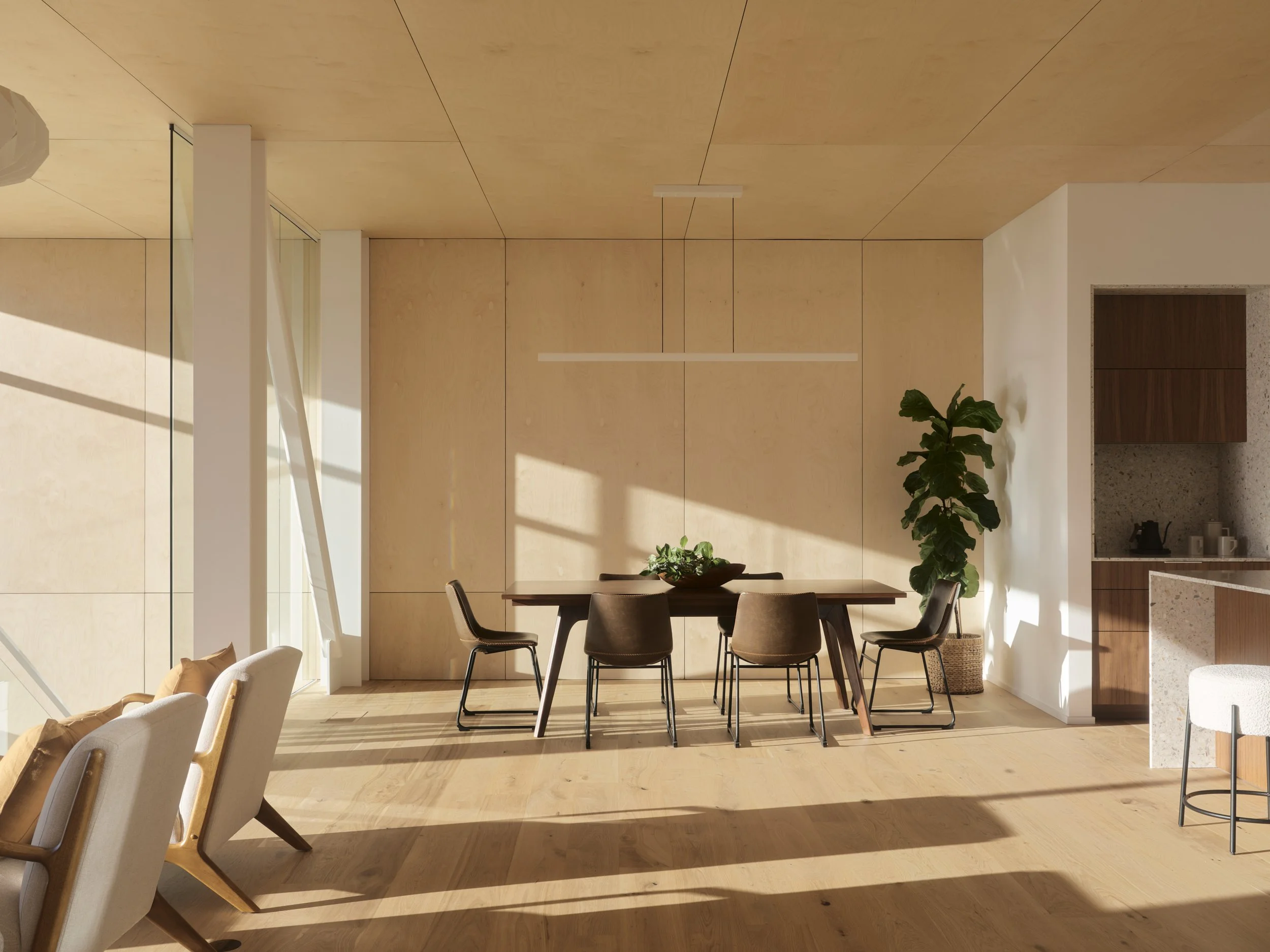Modern dining area with a wooden table, six chairs, a potted plant, and sunlight streaming through large windows.
