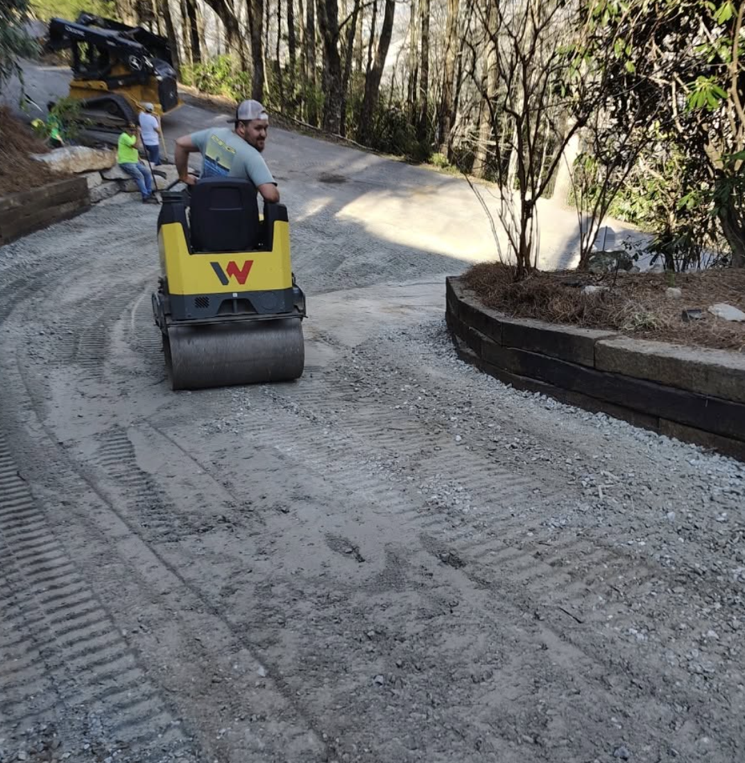 Driveway grading and compaction using professional equipment to create a durable, properly prepared gravel surface by Pro Turf LLC.