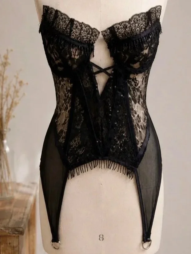 ROCKSTAR LACE BUSTIER — A daring bustier in black sequin and cheetah lace designed with bold textural contrast. Finished with garter-inspired details and silver hardware, it blends lingerie edge with modern, rockstar sophistication.