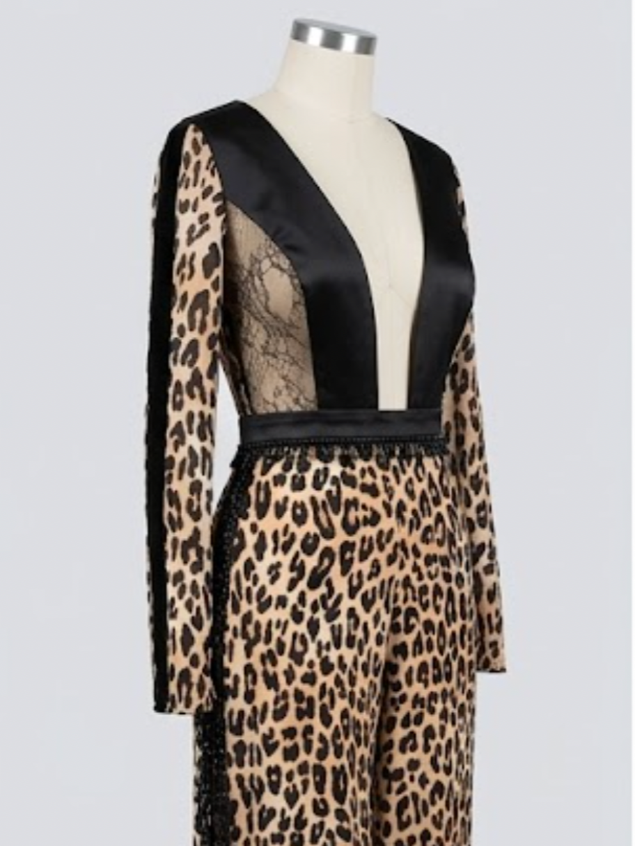 ZENDAYA JUMPSUIT – A cheetah-print jumpsuit with a plunging neckline and dramatic cowl back. Gold and black satin princess seams define the silhouette, while a beaded waist trim adds subtle sparkle.