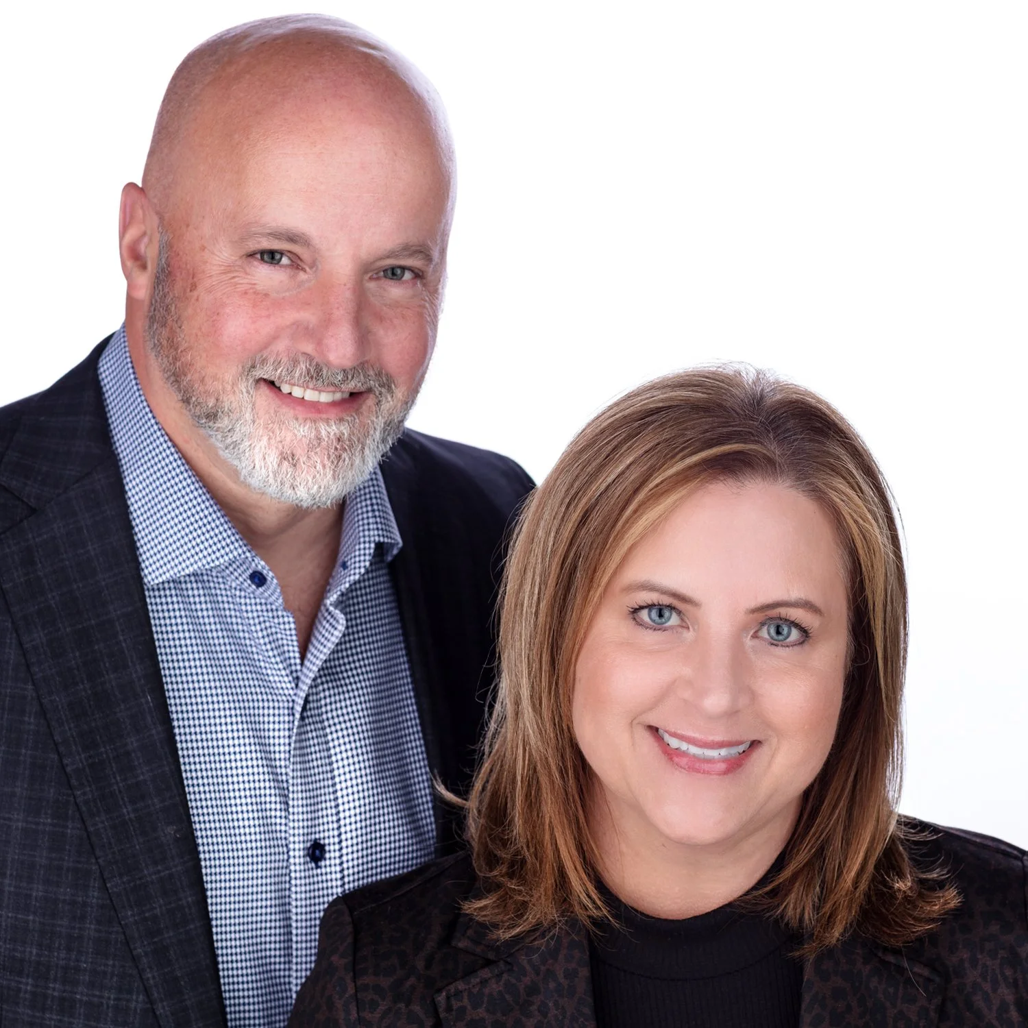 A man with a beard and a woman with light brown hair smiling, portrayed in a professional headshot against a white background.