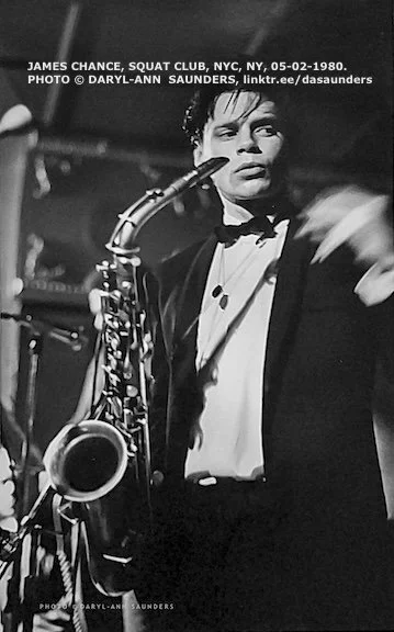 This is a black and white performance photograph by Daryl-Ann Saunders of saxophonist James Chance (of James Chance and the Contortions band), NYC, 1980s.