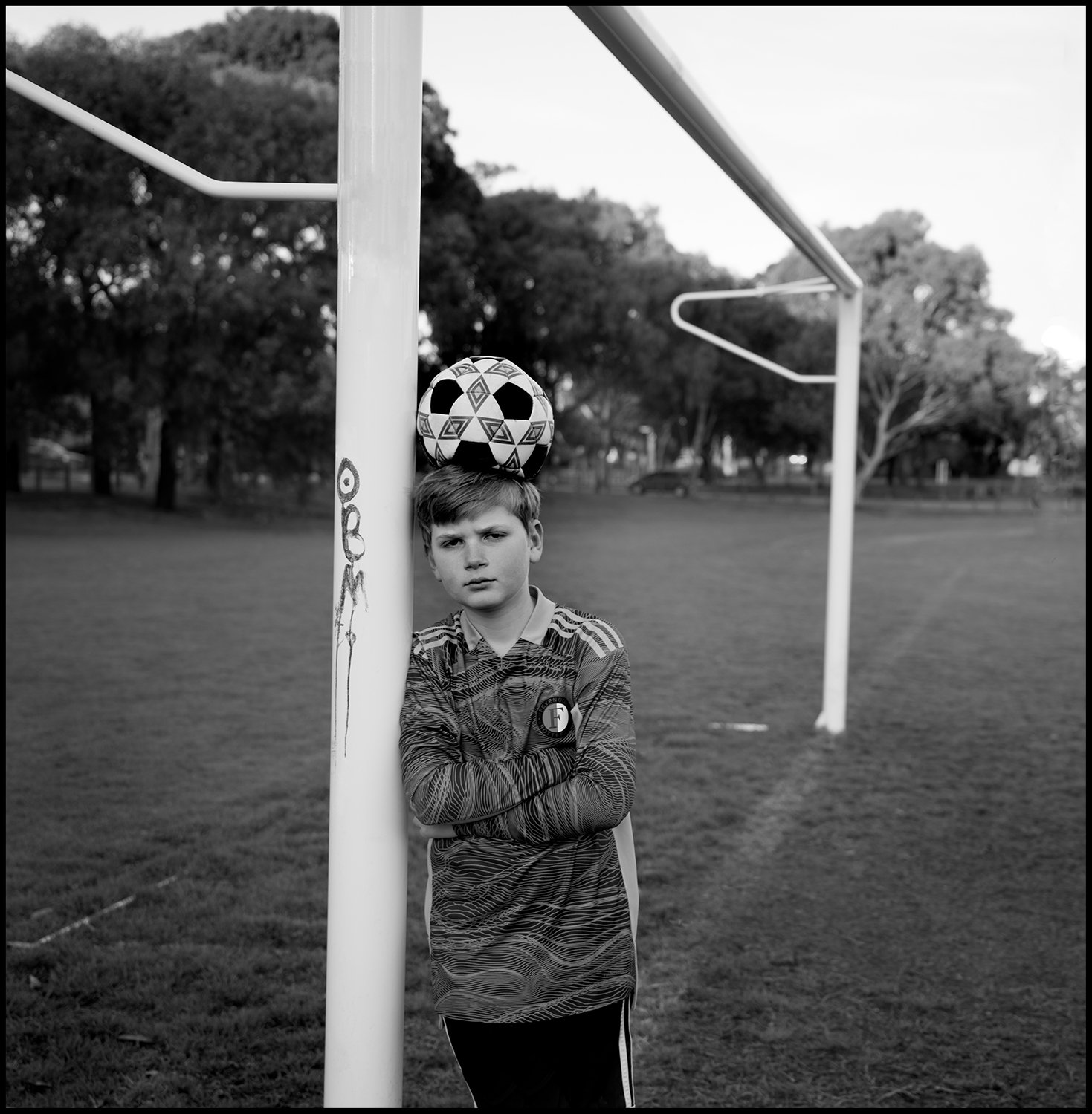 Black and white portrait of a young goalkeeper by Guy Little