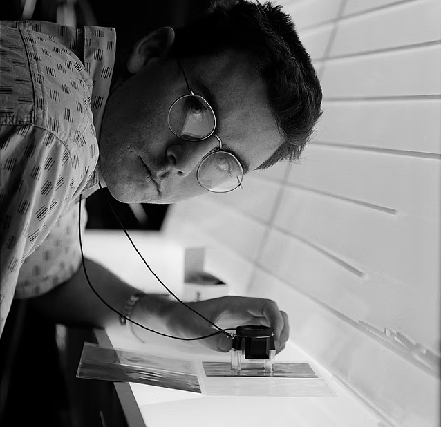 Portrait of Australian photographer Guy Little working with photographic equipment