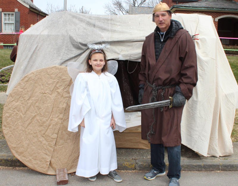 characters in front of makeshift tomb