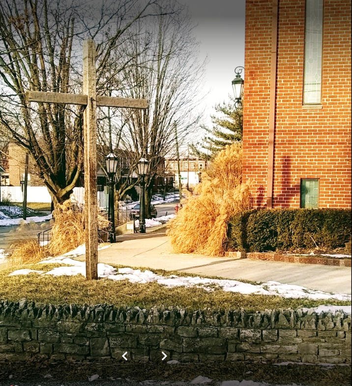 A wooden cross in front of church