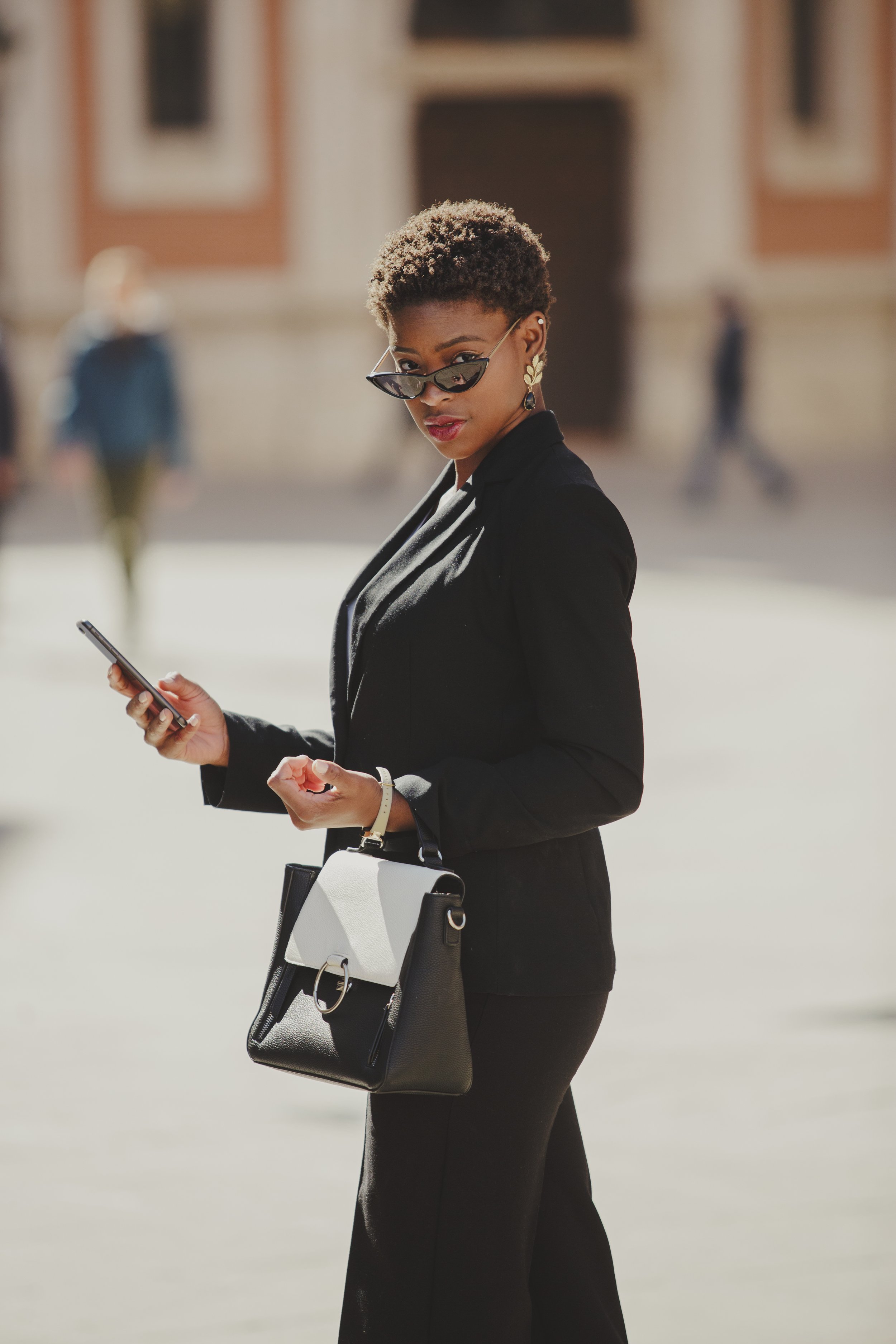 stylish-black-woman-with-handbag-and-smartphone-on-2022-03-04-05-56-22-utc.jpg