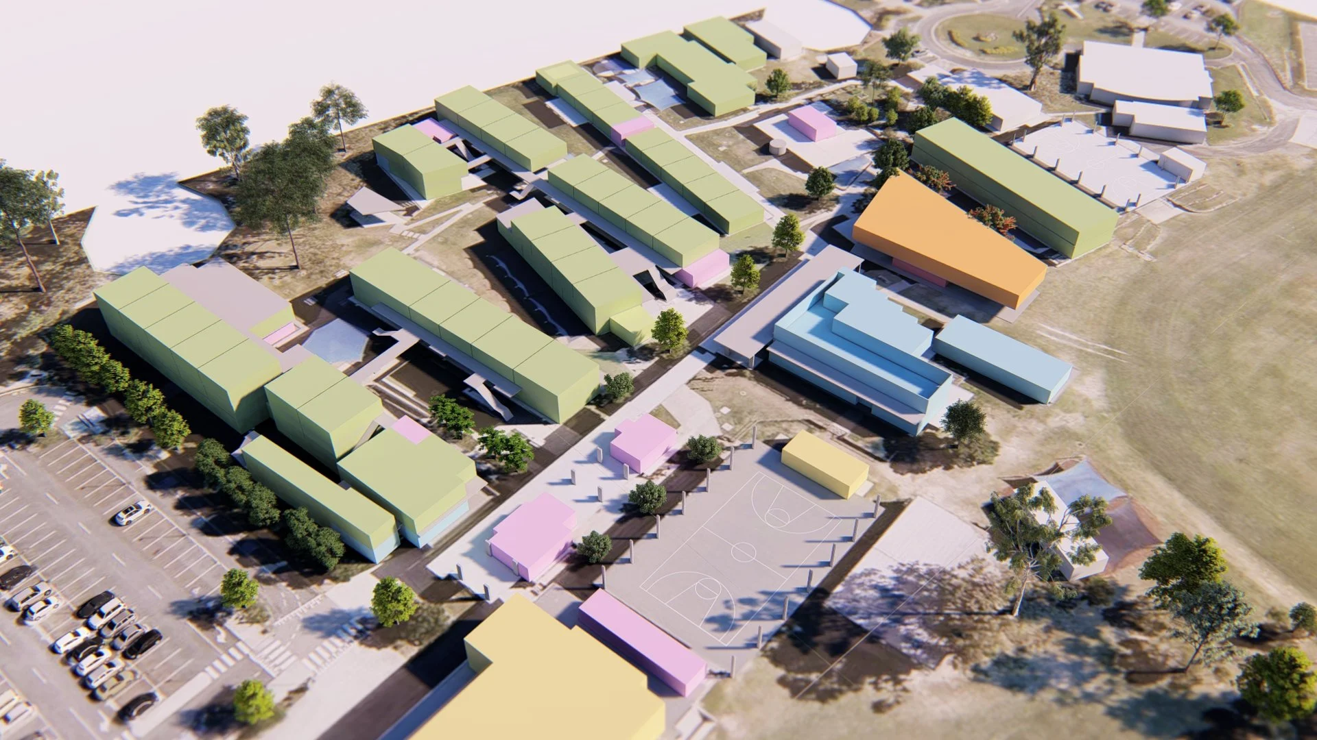 Aerial view of a school campus with colorful buildings, a basketball court, parking lot, and surrounding trees.