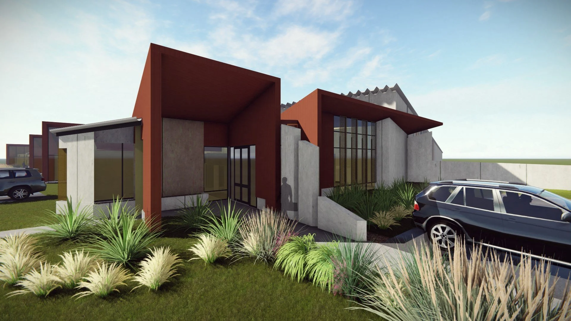 Modern building with angular design, large glass windows, and landscaped front yard with drought-tolerant plants; parked cars are visible nearby.