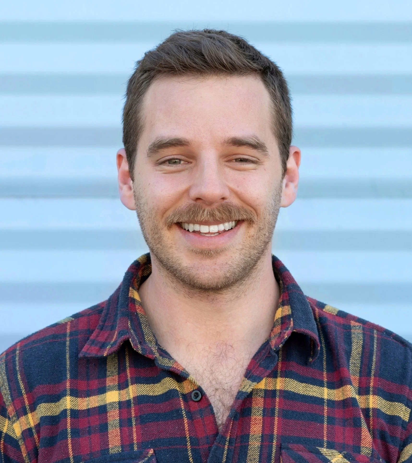 Headshot of Travis Althouse, licensed SLP, stutterer, content creator @travis.stuttering, and author of Finn Finds His Voice.