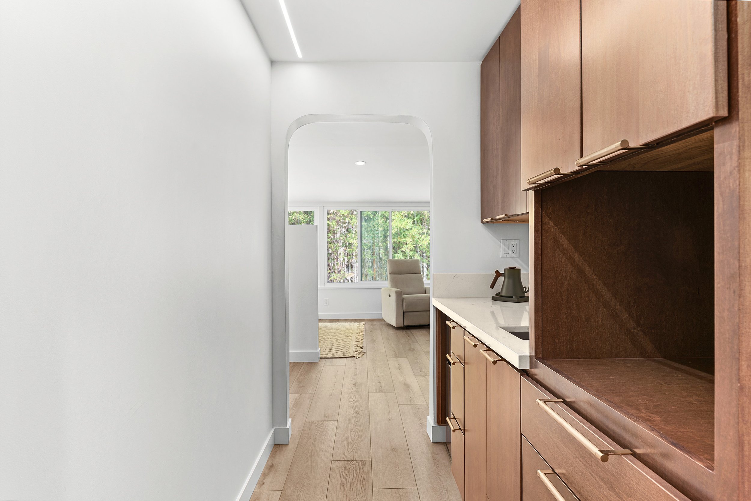 primary-suite-kitchenette-coffee-bar-arched-doorway-la-jolla.jpg