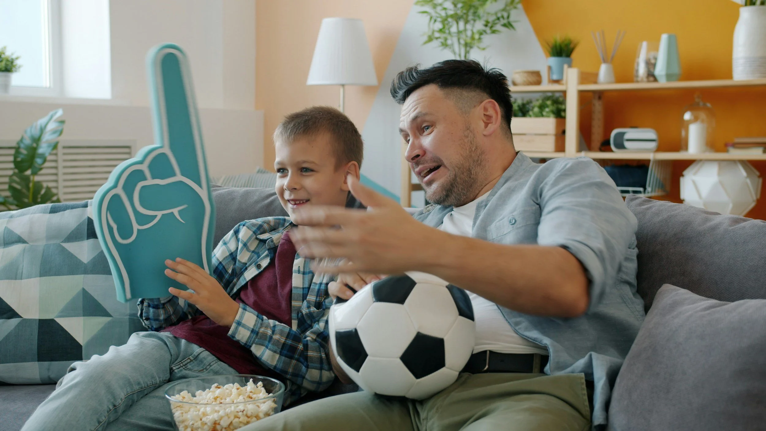 father with son watching football