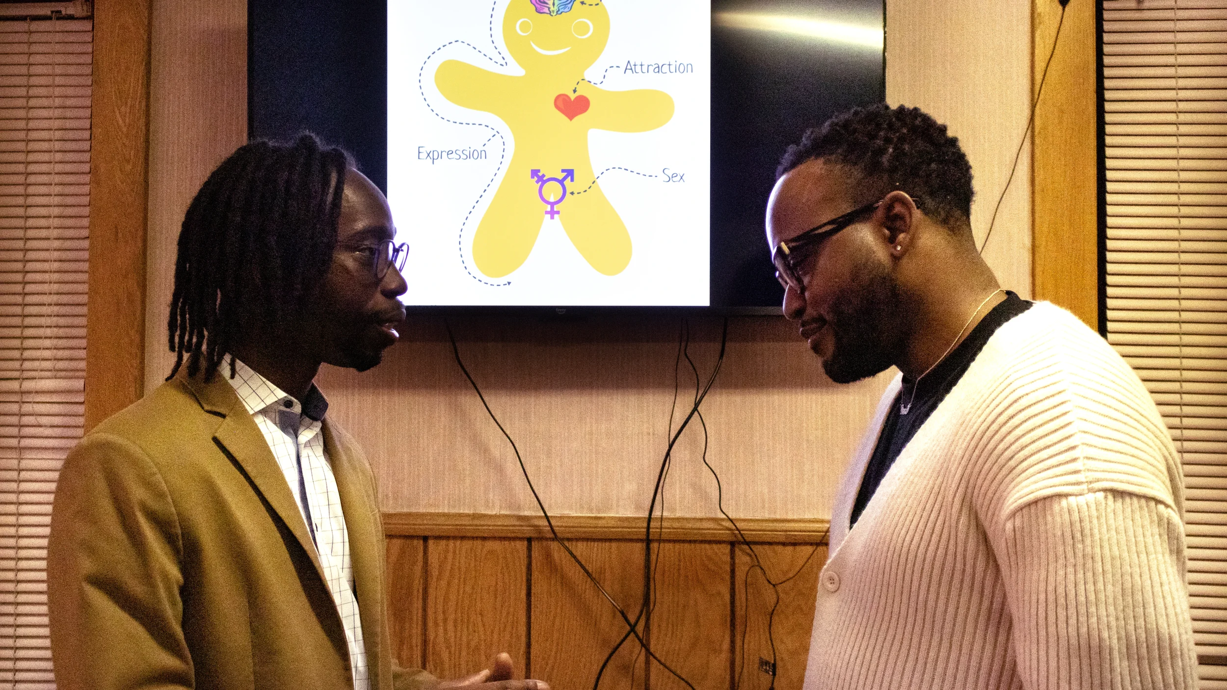 Pastor Don Abram (left) and Calvin Taylor (right) chat while they present the “genderbread” person, which visually explains the components of gender as an umbrella term: sex, gender identity, gender expression, and attraction.