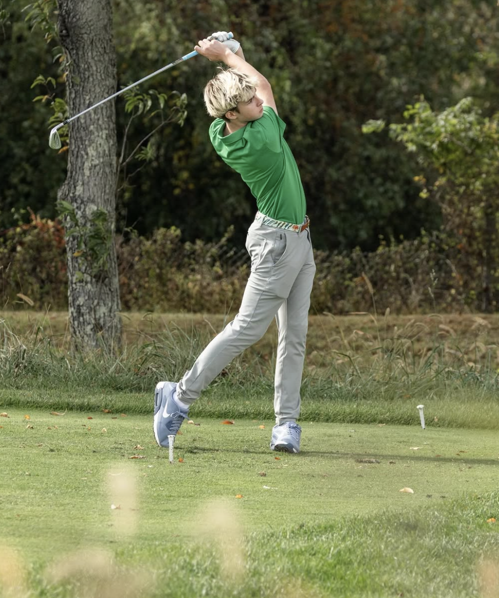Henry Anderson hitting a golf tee shot during a tournament.