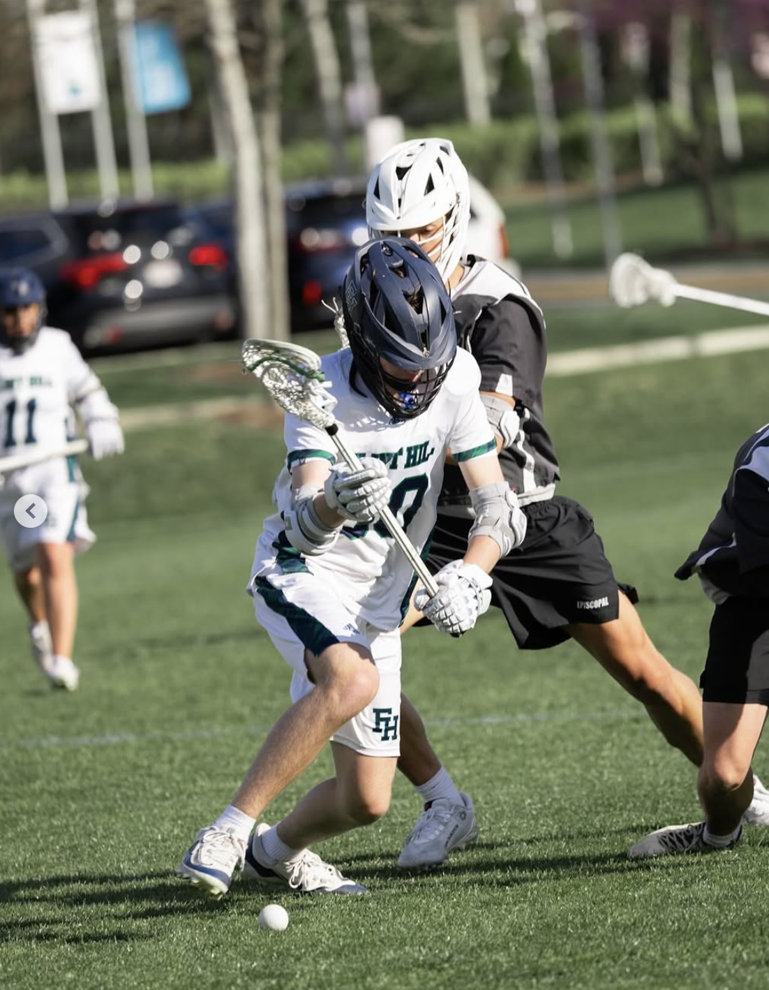 Henry Anderson playing in a lacrosse game while carrying the ball.