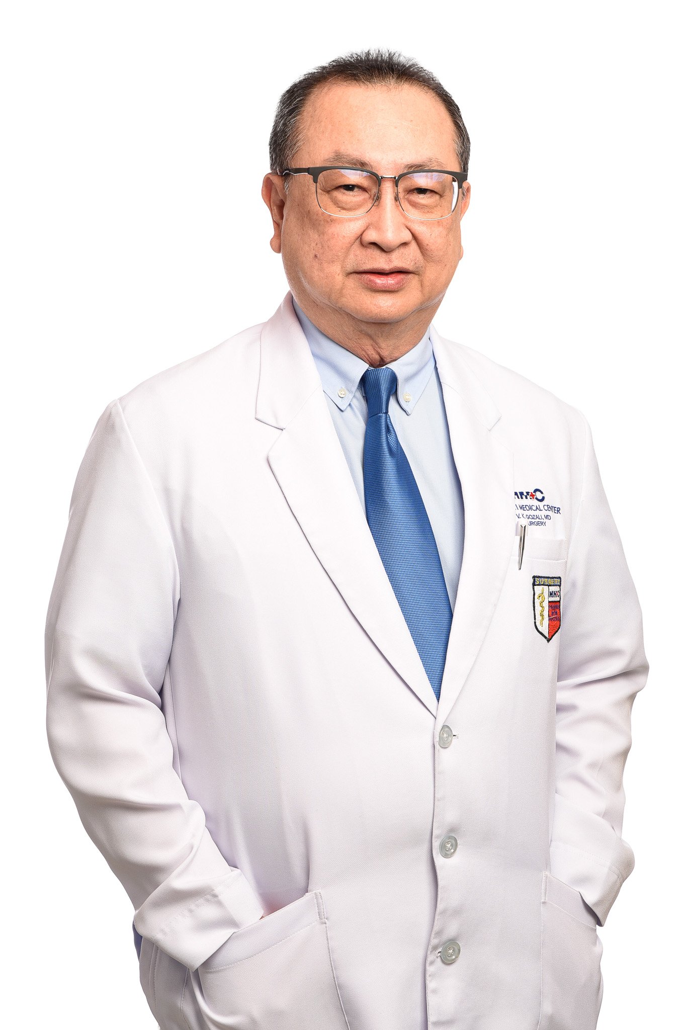 A middle-aged man in a white doctor's coat with glasses standing against a white background.