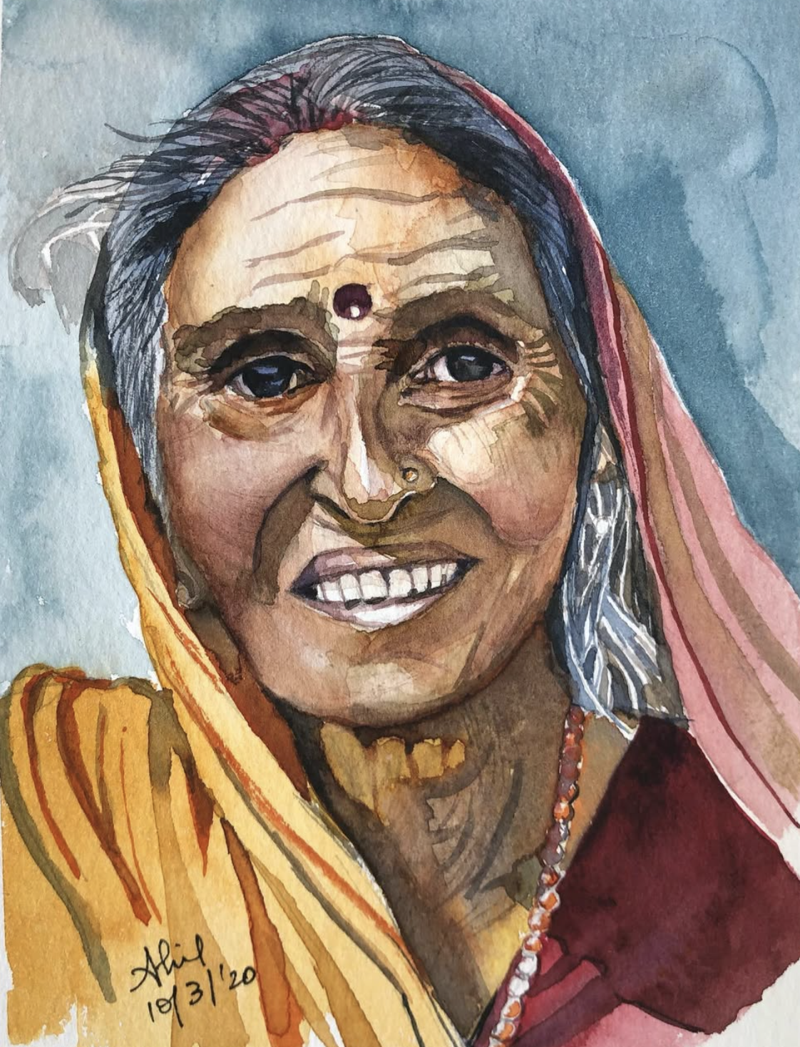 Original hand-painted watercolor portrait of a smiling elderly Indian woman wearing a saffron sari, bindi, nose ring and prayer beads, painted on 300gsm cotton paper by Ivory and Ink.