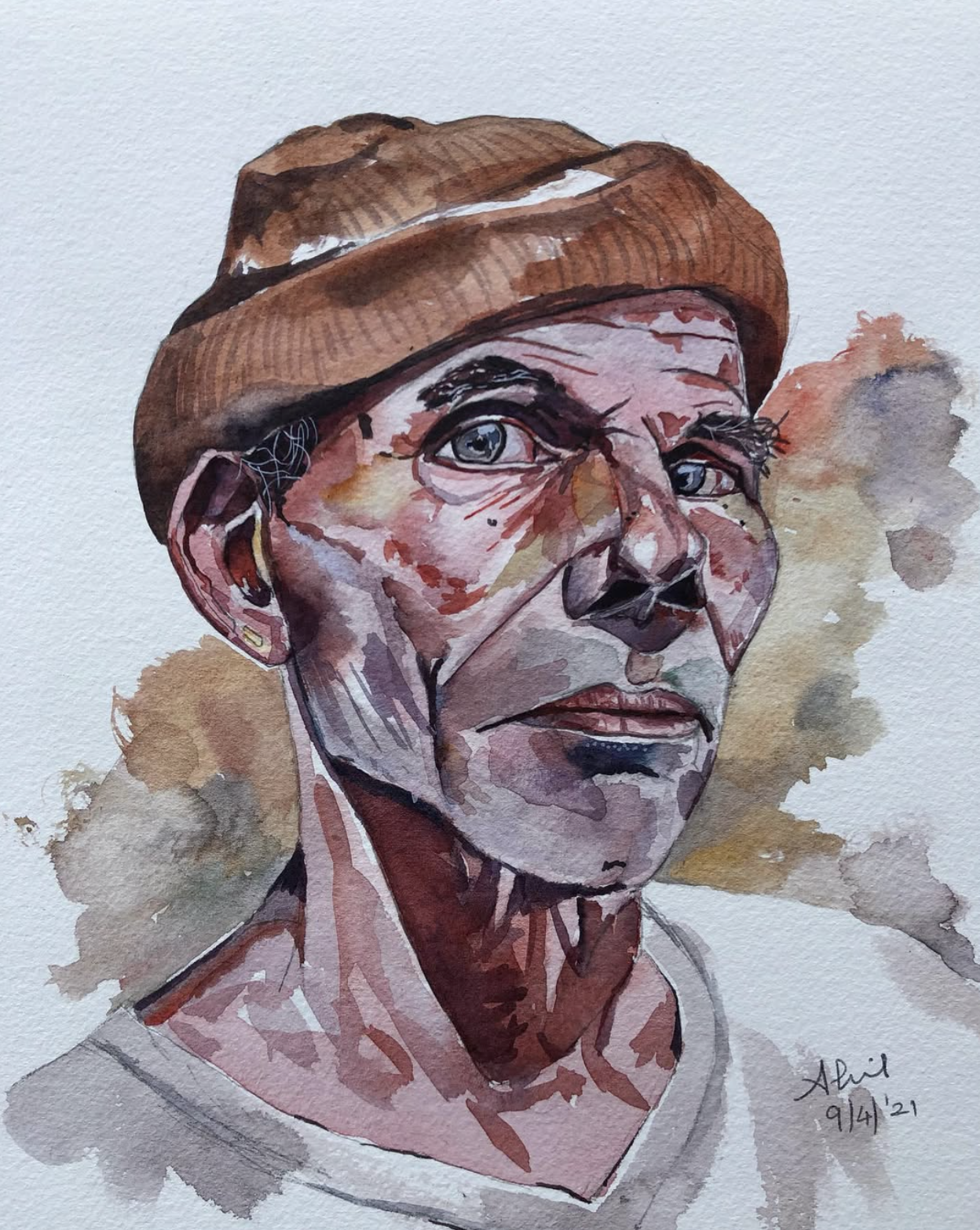 Original hand-painted watercolor portrait of an elderly man wearing a brown cap with pale blue eyes and weathered features, loose background washes in warm earth tones, painted on 300gsm cotton paper by Ivory and Ink.