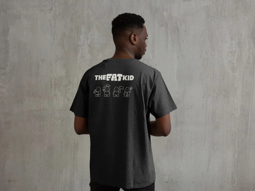 A man wearing a shirt branded with The Fat Kid logo