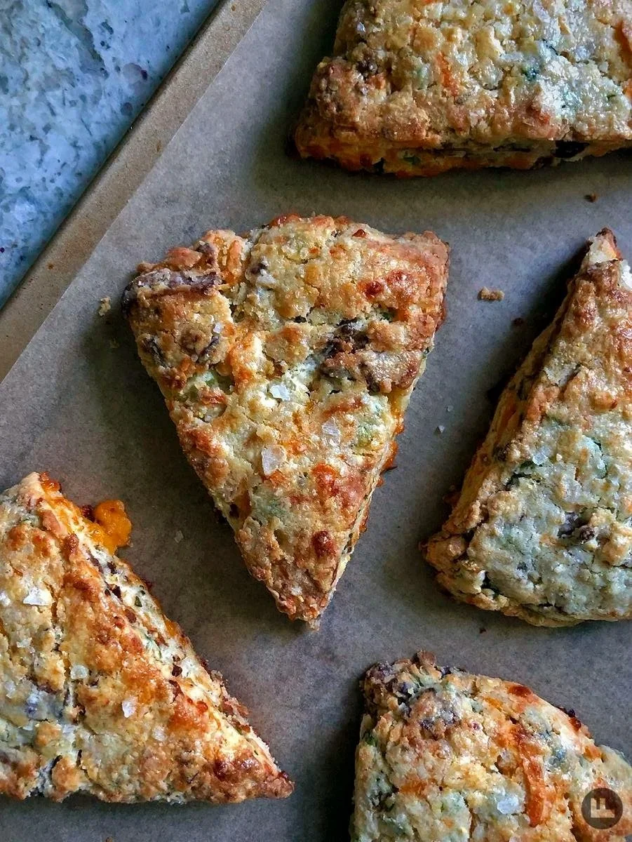 Close-up of slices of vegetable quiche with a golden, crispy crust on parchment paper.