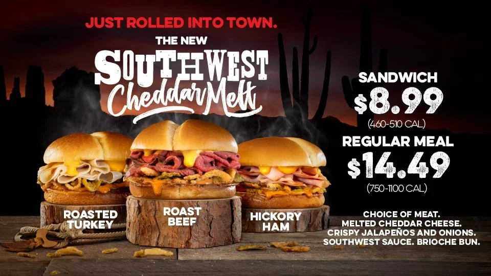 Three sandwiches on wood slices with smoked turkey, roast beef, and hickory ham, set against a dark sunset background with desert silhouettes, advertising Southwest Cheddar Melt sandwiches, priced at $8.99 for a sandwich and $14.49 for a regular meal