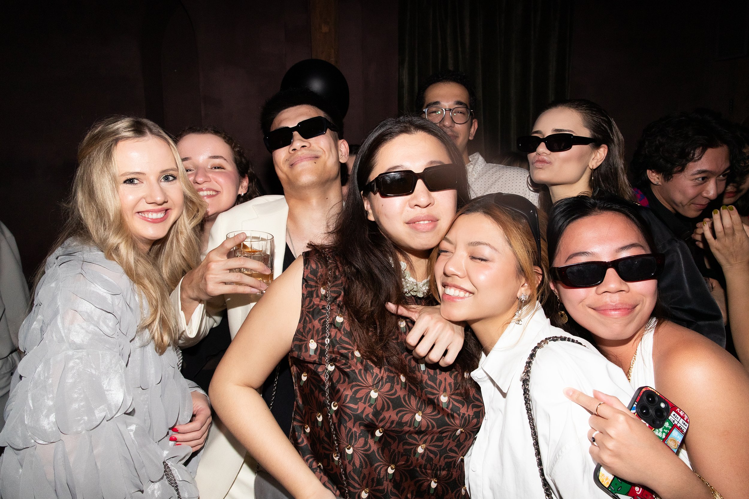 Group of people wearing 3D glasses, celebrating at the debut party of ANG Concept, "La Genèse" in Chapel Bar, New York.