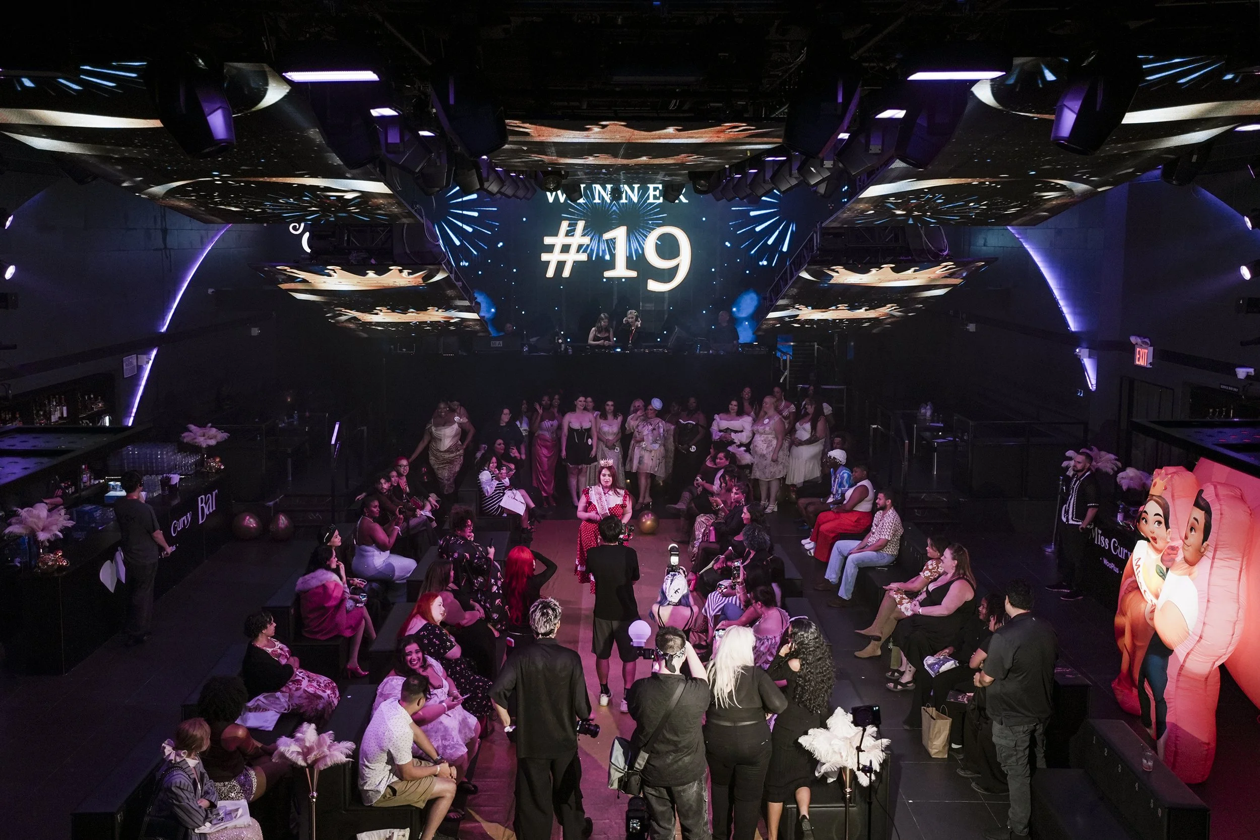 In Times Square nightclub Nebula, model #19  in a Lacemade dress announced to be the queen of Miss Curvy Pageant 2025 by WooPlus during NYFW.