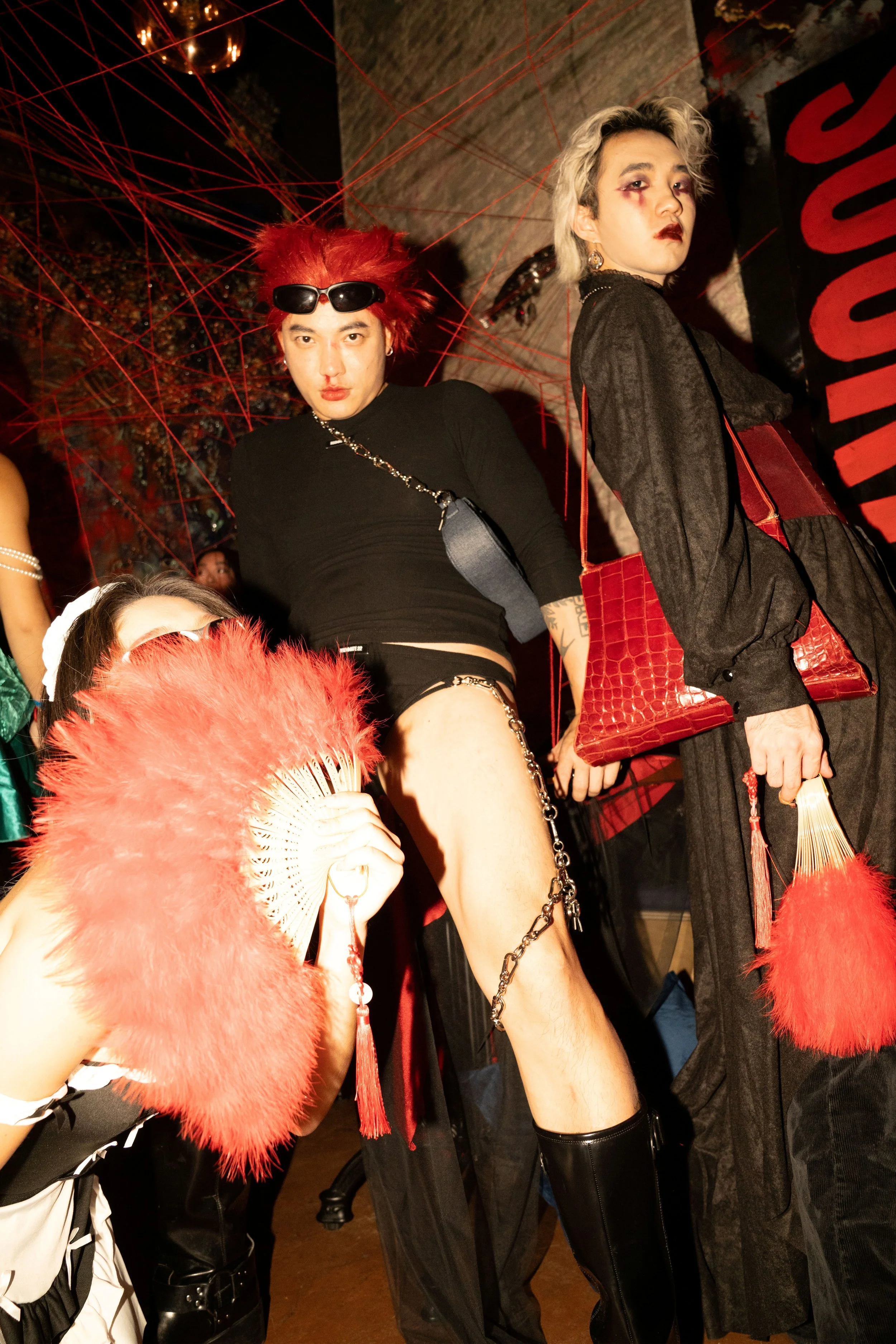 Three individuals from designer swimwear brand Roommate 22 dressed up for Madame Rouge, a haunted-house-inspired Halloween activation in New York by experiential production agency ANG Concept.