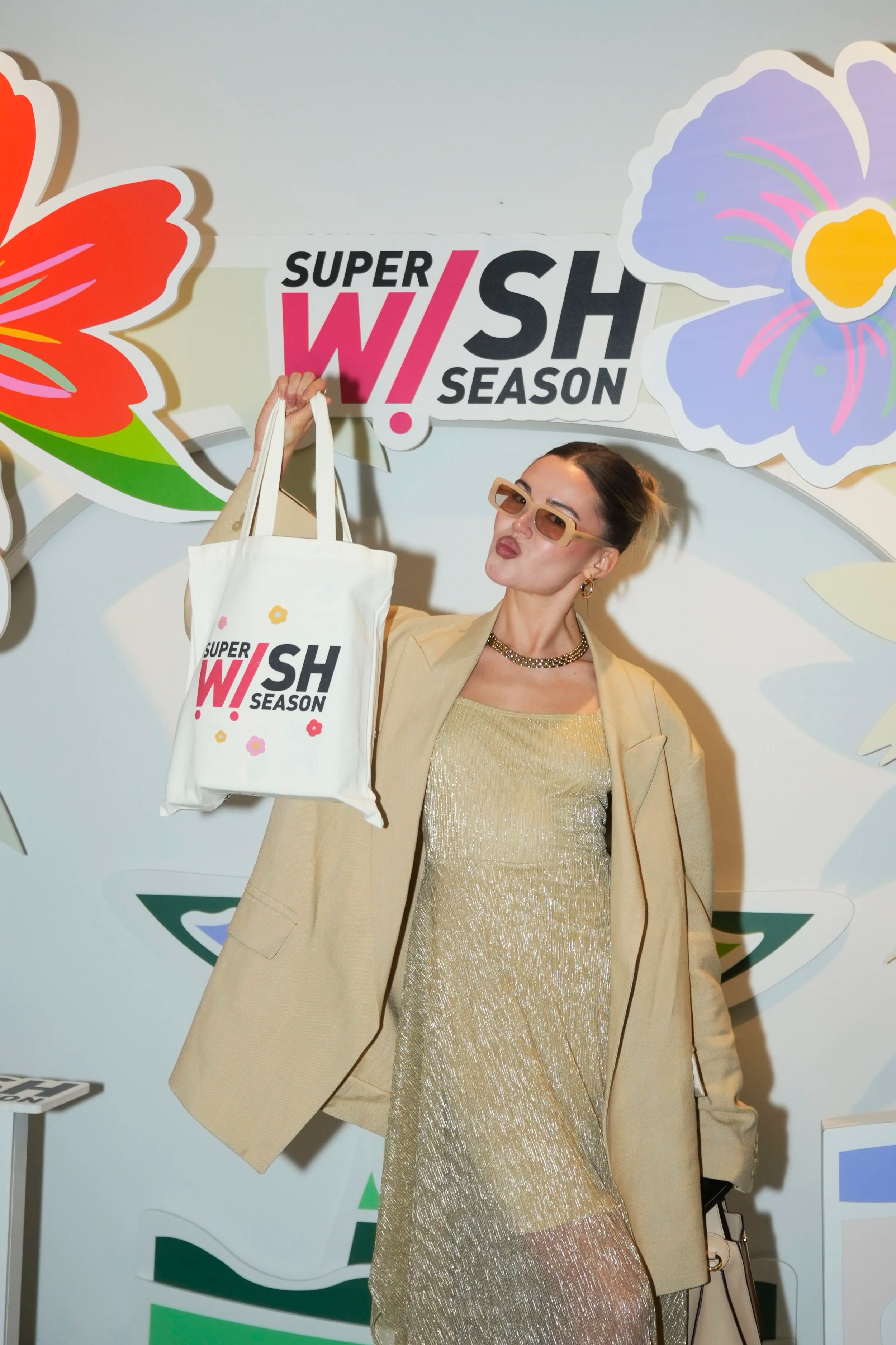 A VIP guest holding a gift bag at the photo call from the TikTok Super Wish Season pop-up activation by event production agency ANG Concept.