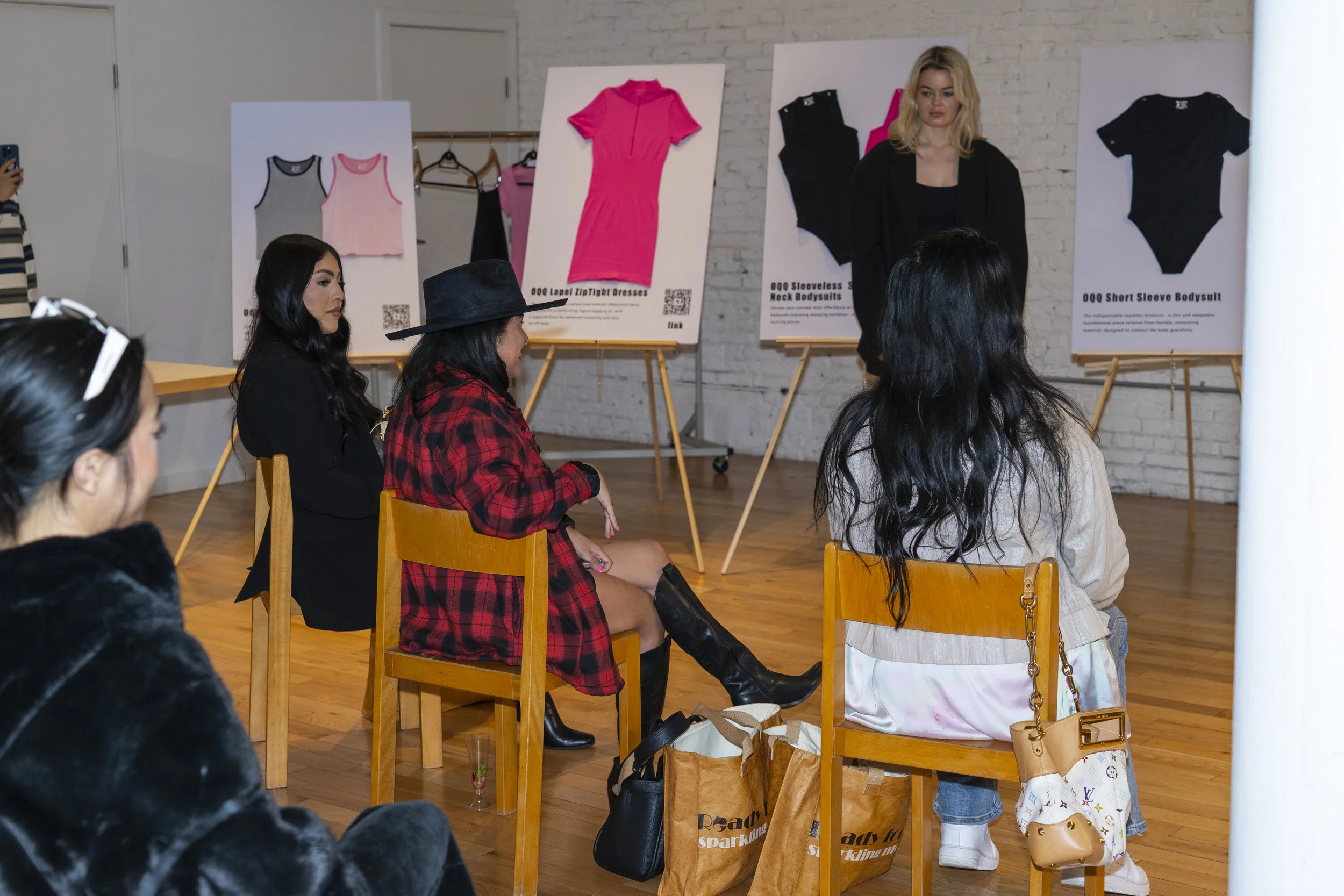 A fashion presentation with a woman modeling clothing from Women's Activewear, Gymwear, and Athleisure brand OQQ's press conference in Williamsburg.