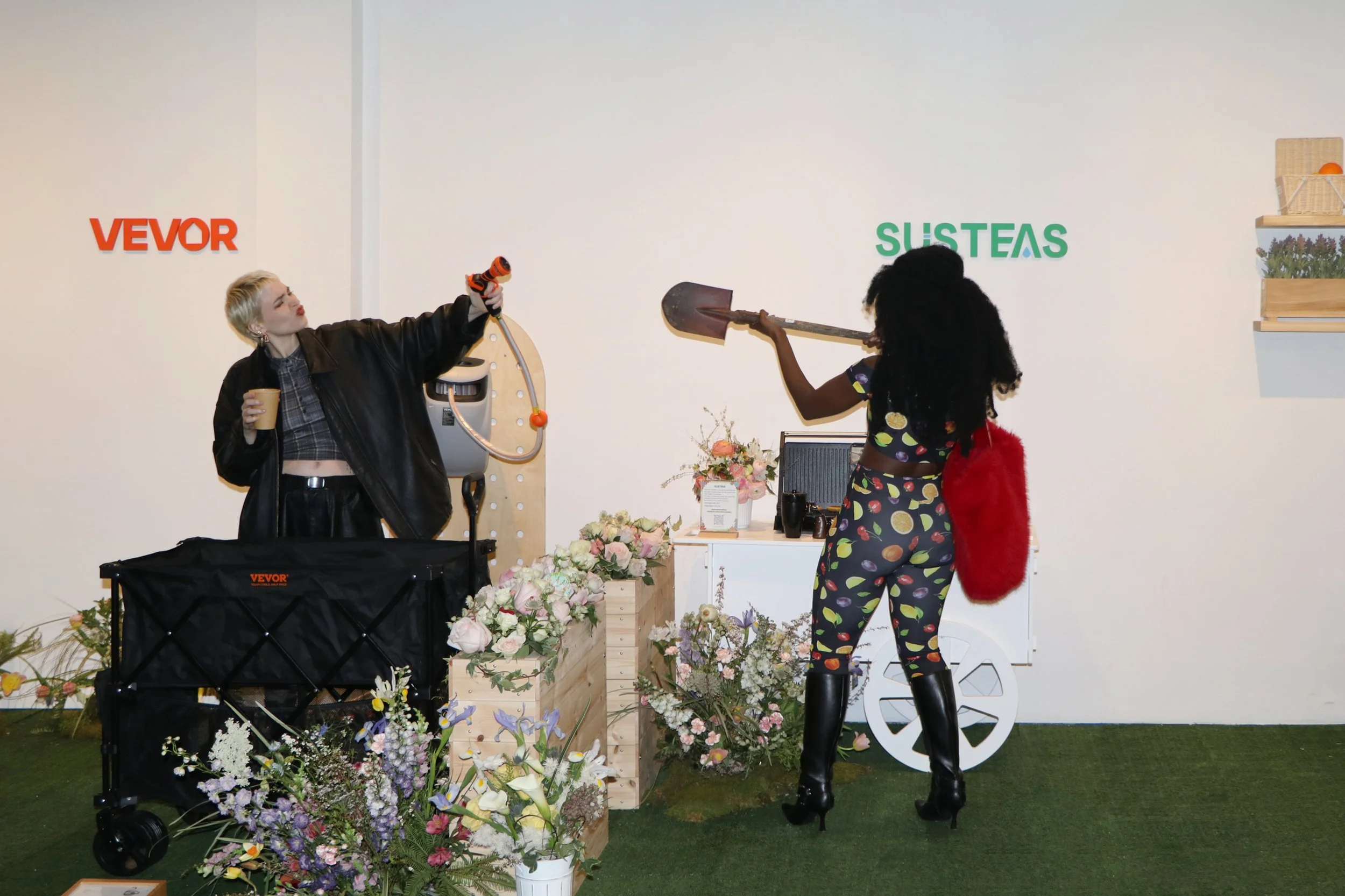 Two KOLs interacting with the irrigation product from Vevor and prop from Susteas at Super Wish Season pop-up by experiential production agency ANG Concept.