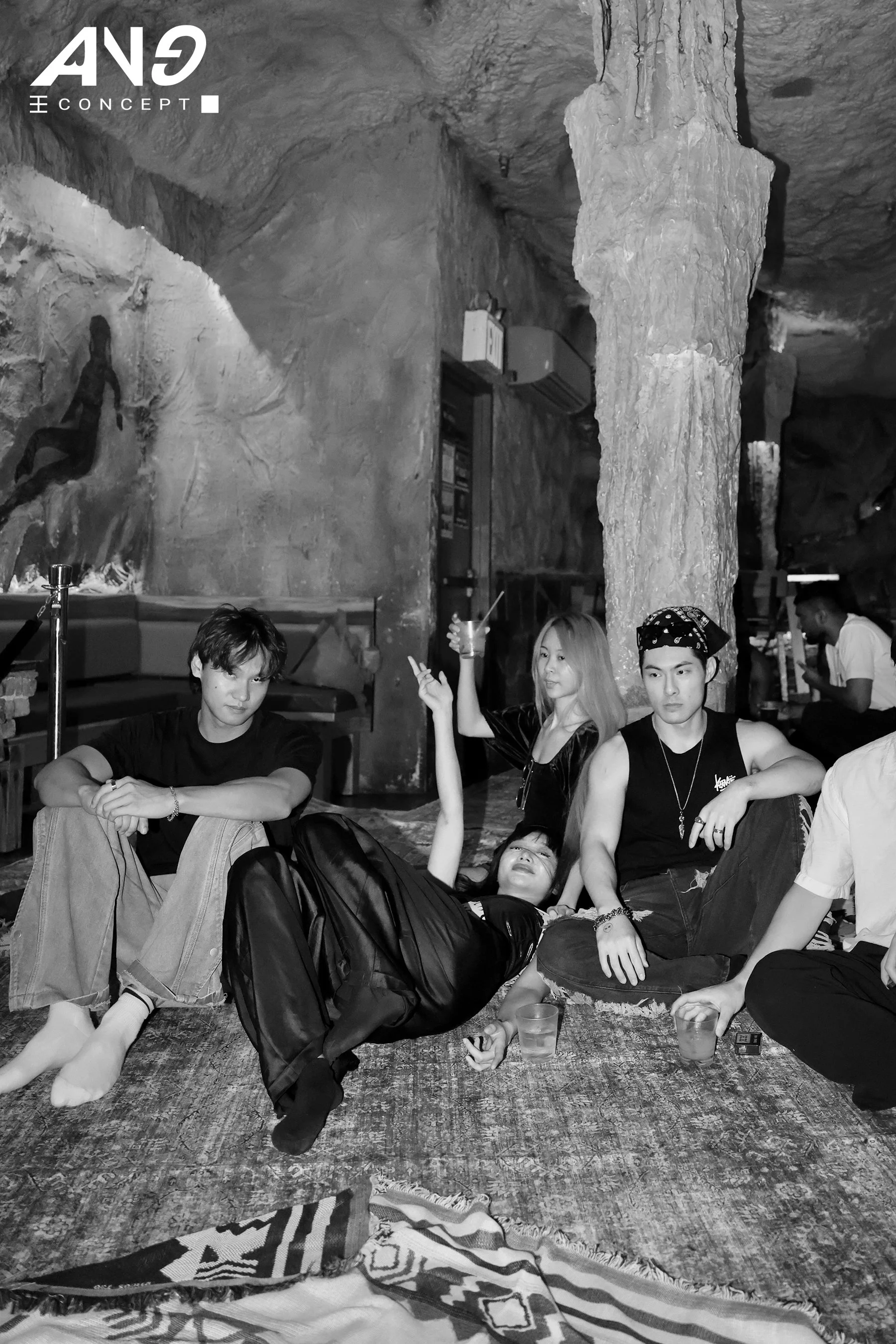 Creators lying on a rug inside a cave at the Lay Party by New York-based experiential production agency ANG Concept