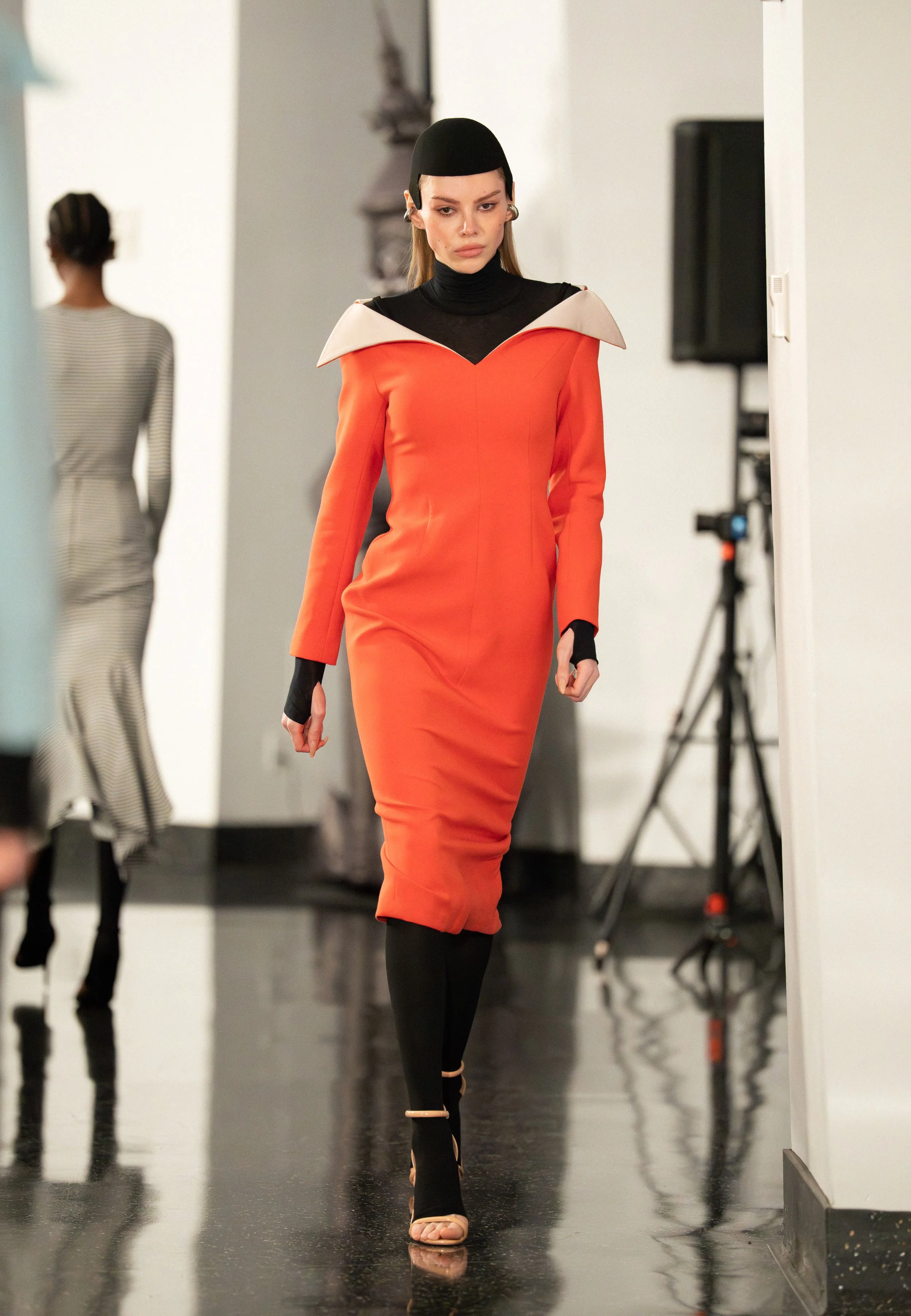A VICKTEERUT model walking down the runway of "Up to the Sky" Bangkok designer fashion show by experiential production agency ANG Concept during NYFW at One World Observatory.